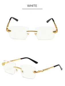 Detail of rimless diamond cut sunglasses with golden snake-shaped metal temples in white