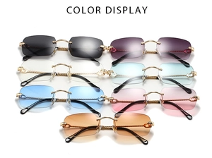 Color display of rimless polygon sunglasses with gold metal temples and C-decor hinges