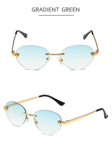 Close-up of rimless gradient green sunglasses with golden metal cheetah head hinges