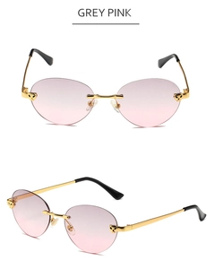 Detail view of rimless grey pink sunglasses with golden leopard head accent and metal temples