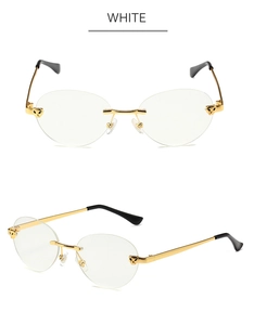 Detailed close-up of golden metal panther head embellishments on rimless sunglasses