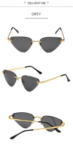 Detail view of grey rimless cat eye sunglasses with gold wave temples and metal leopard accent