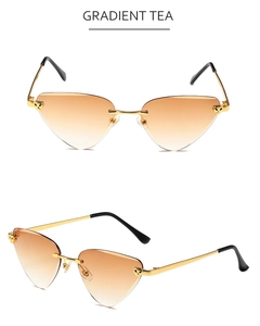 Macro detail of rimless cat-eye sunglasses with gradient tea lenses and leopard metal accents