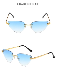 Detail of rimless cat-eye sunglasses with gradient blue lenses and wavy gold metal temples
