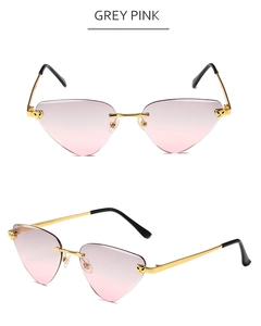 Detail of rimless leopard sunglasses showing golden panther accent and grey pink lenses