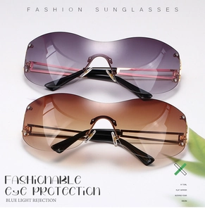 Close-up of frameless square sunglasses with gradient lenses and gold metal temples