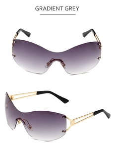 Close-up of gradient grey lenses and sleek gold metal temples on rimless sunglasses