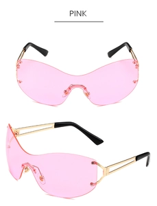 Detail of pink rimless oversized butterfly sunglasses with golden hollow metal temples