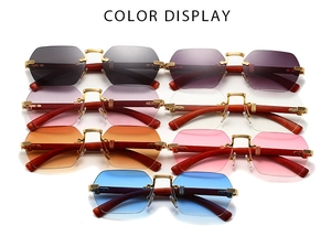 Detail of rimless hexagonal sunglasses with gold metal hinges and premium wood temples