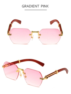 Detail of gradient pink rimless octagon sunglasses with gold metal hinges and wood arms