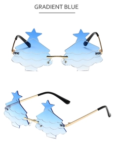 Detail view of star-topped rimless Christmas tree party sunglasses with blue gradient lenses