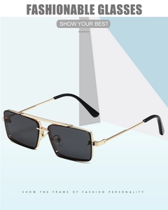 Close-up of square sunglasses featuring sleek gold metal temples and black frames