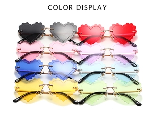Detailed color display of rimless heart-shaped sunglasses with wavy edges and metal frames