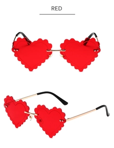 Detail of red heart-shaped rimless sunglasses with wavy edges and gold metal frames