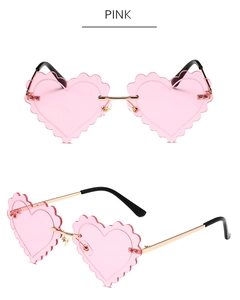 Macro detail of heart-shaped rimless sunglasses with pink wave lenses and golden frame