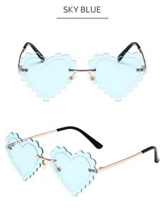 Detail of sky blue heart-shaped rimless sunglasses with wave-cut edges and gold frame