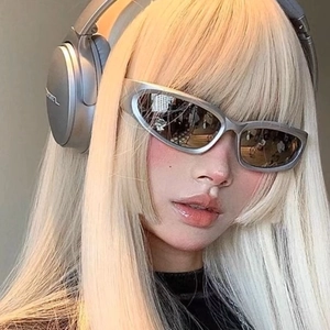 Close-up of Y2K steampunk sunglasses with silver wrap-around frame on model