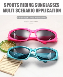 Detail of rose pink and cyan blue sport cycling sunglasses on a marble surface