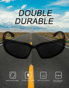 Detail of steampunk sports sunglasses with carbon fiber frame and dark lenses over road background