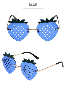 Macro detail of strawberry-shaped sunglasses with blue lenses and golden metal frames