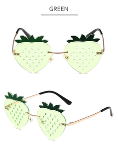 Detailed macro view of green strawberry shaped lenses with unique gold metal temples