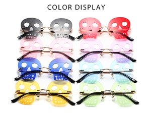 Detail of rimless skull sunglasses in multiple transparent colors with gold metal frames