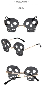 Detail of grey skull shaped rimless sunglasses with gold metal frames and black temples