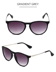 Detail view of retro aviator sunglasses with gradient grey lenses and silver metal temples