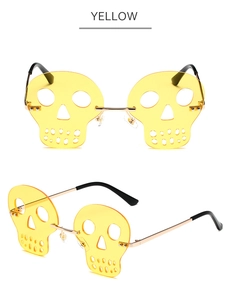 Detail view of yellow skull-shaped rimless sunglasses with gold metal temples for party