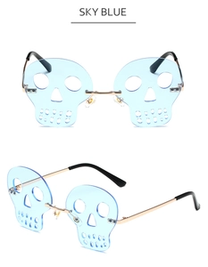 Detail view of sky blue rimless skull-shaped sunglasses with gold metal bridge and temple