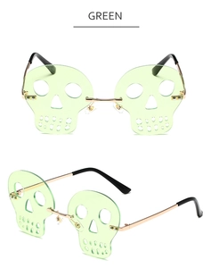 Macro detail of rimless green skull sunglasses with rose gold metal temples and carving