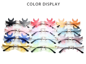 Detailed color display of rimless bat-shaped sunglasses in twelve vibrant lens shades