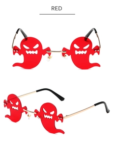 Detail view of red ghost shaped rimless sunglasses with gold metal frames for parties