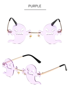 Detail view of purple rimless ghost-shaped sunglasses with golden metal frame
