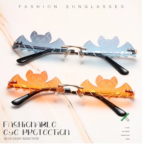 Detail of bat-shaped rimless sunglasses in grey-blue and orange-yellow metal frames