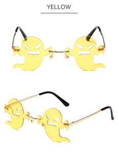 Close-up of yellow ghost shaped rimless sunglasses with gold metal frame for parties