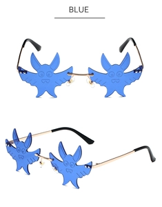 Detail view of blue bat-shaped rimless sunglasses with gold metal frame and unique engraving