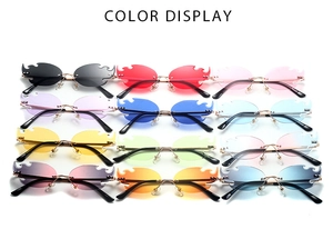 Matrix display of 12 colorful flame-shaped rimless sunglasses with gold metal frames