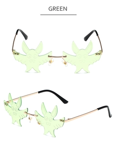 Detail of green rimless bat-shaped lenses with golden metal bridges and temples
