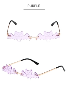Detailed view of bat-shaped rimless sunglasses with purple lenses and gold metal temples