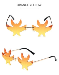 Detail view of orange yellow gradient bat shaped rimless sunglasses with gold metal temples