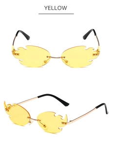 Detail view of flame-shaped rimless sunglasses in yellow with metallic frame