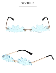 Macro view of sky blue bat-shaped rimless sunglasses with gold metal temples