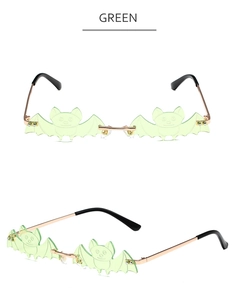Detail view of green bat-shaped lenses with gold metal frames and comfortable nose pads