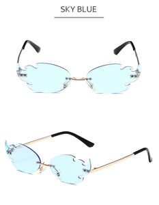 Detail view of flame-shaped sky blue rimless sunglasses with gold metal temples