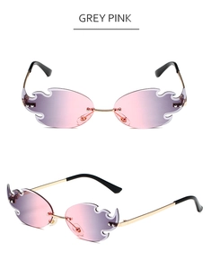 Macro detail of fire-shaped rimless sunglasses with pink-grey gradient lenses and gold temples