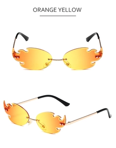 Detail of flame-shaped rimless sunglasses with orange-yellow gradient lenses and gold temples