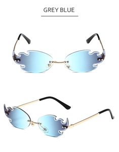 Detail view of flame-shaped rimless sunglasses in grey blue gradient and gold metal frame