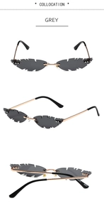 Macro view of grey leaf-shaped rimless sunglasses with gold metal frame and details