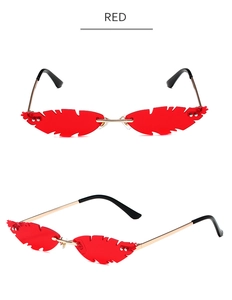Macro detail of red flame-shaped rimless sunglasses with gold metal temples and red lenses